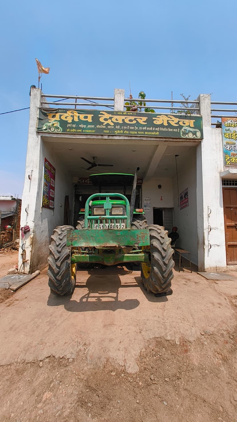 Tractor in front of garage